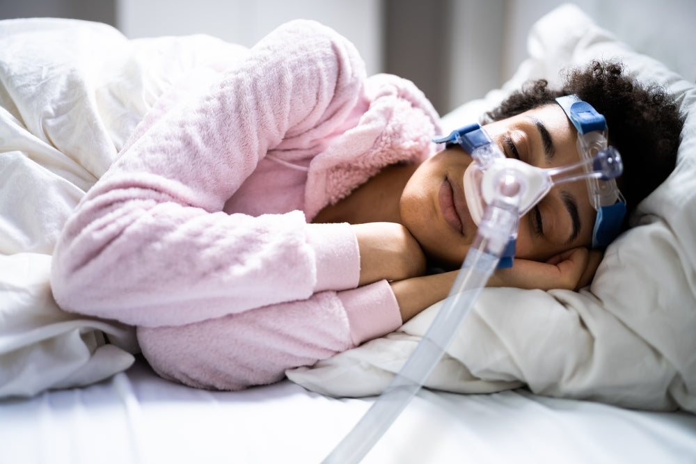 A woman sleeping comfortably with her cpap machine