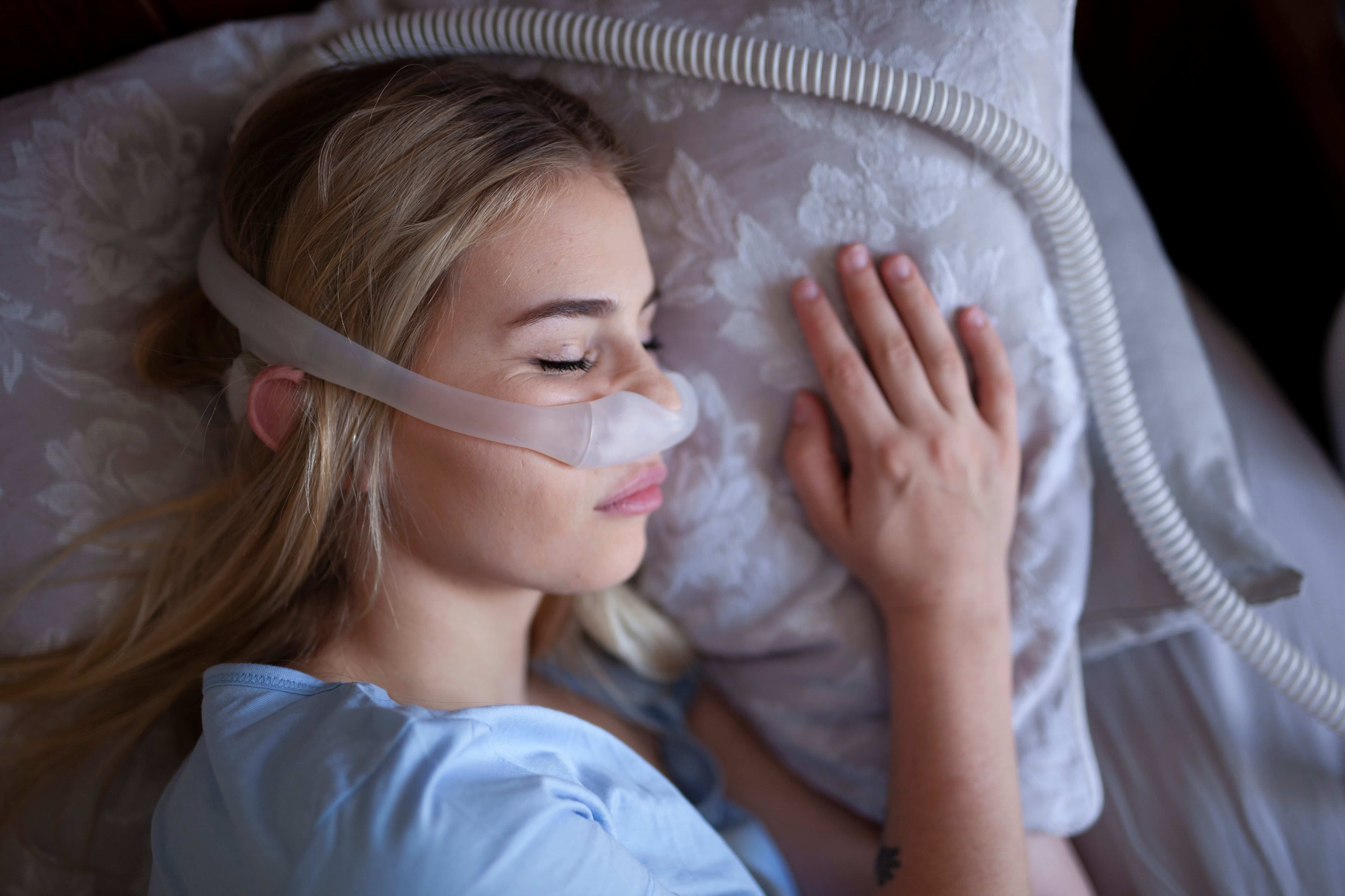 A person using a CPAP machine and mask.